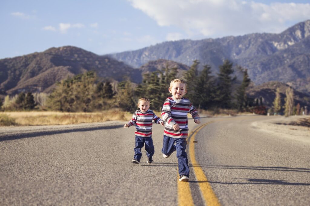 "Niños jugando en la carretera bajo la supervisión de su au pair"